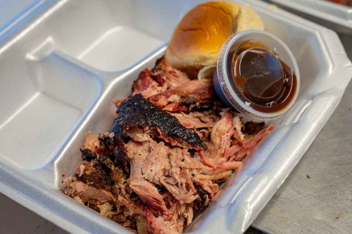 Pulled pork with sauce and a roll