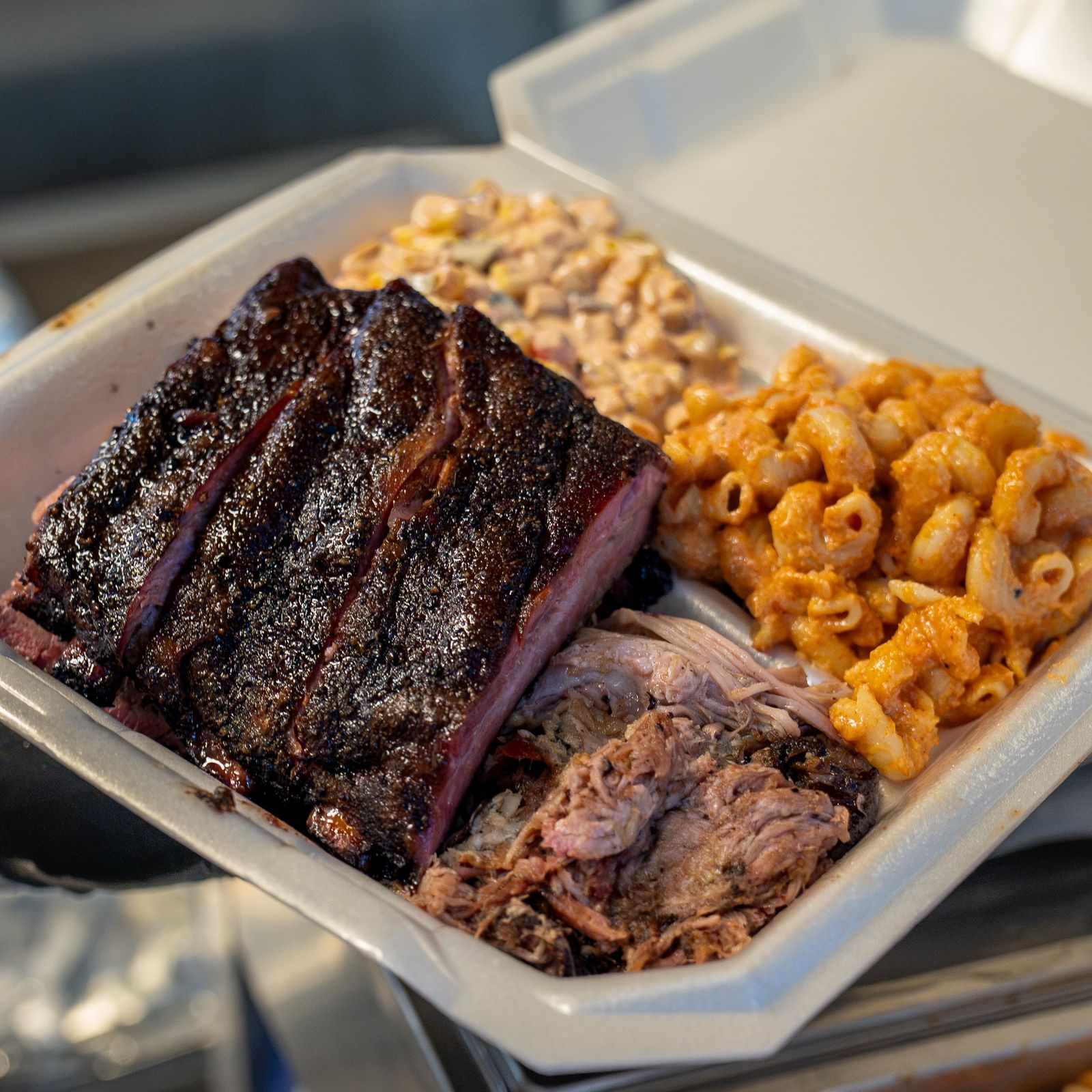 Loaded plate of St. Louis ribs, pulled pork and mac & cheese